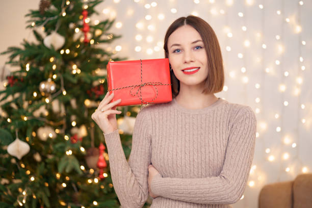 istock Portrait young beautiful woman hold a gift box 1286906734