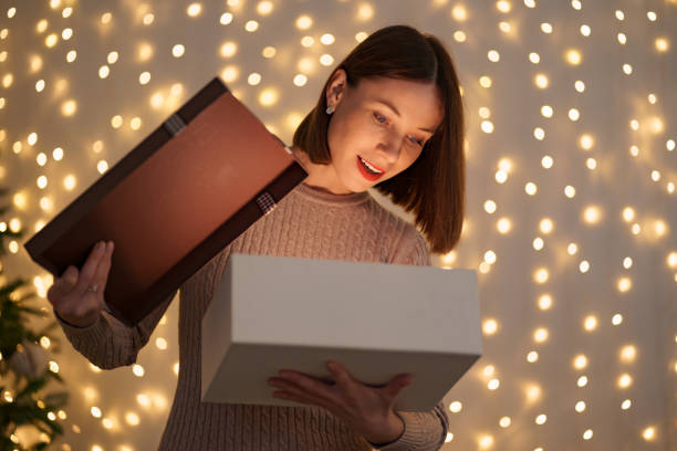 istock Happy beautiful woman opening a gift 1286906742