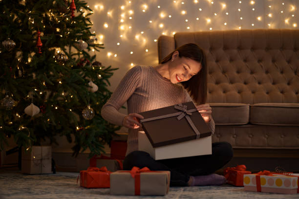 istock Happy beautiful woman opening a gift 1286906750