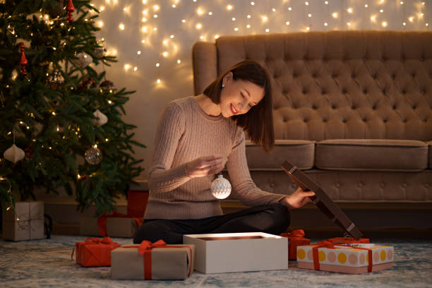 istock Happy beautiful woman opening a gift 1286906752