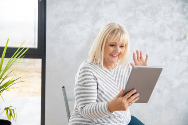 istock Mature Woman Communicating Through Digital Tablet 1286907806