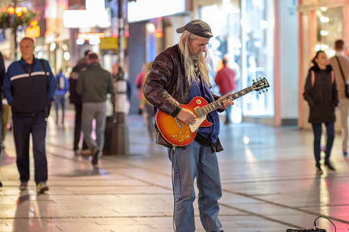 Belgrade / Serbia - September 25, 2018: Old rocker playing an electric guitar in pedestrian Knez Mihailo Street in central Belgrade, Serbia