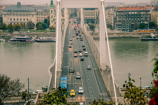 City traffic on the Elizabeth bridge in Budapest has not stopped even during the covid-19 lockdown. Parking in the city is free and people were asked to used personal instead of public transport.