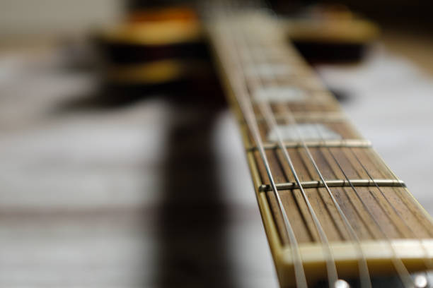 istock Rosewood neck six string guitar long perspective close up still 1286911386