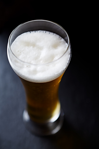 Glass of beer on dark background. Close up.