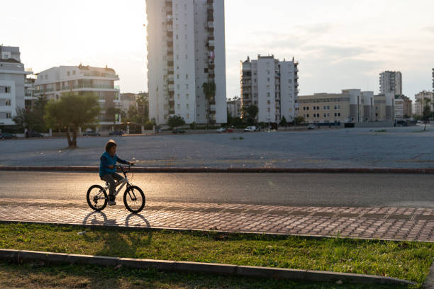 istock Elementary Schoolboy Riding Bike In Public Park 1286911776