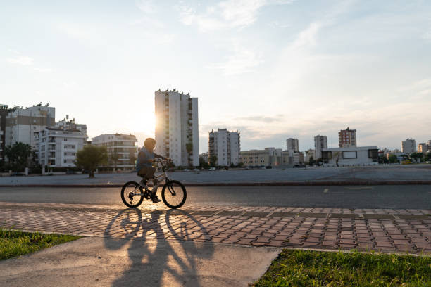 istock Elementary Schoolboy Riding Bike In Public Park 1286911777
