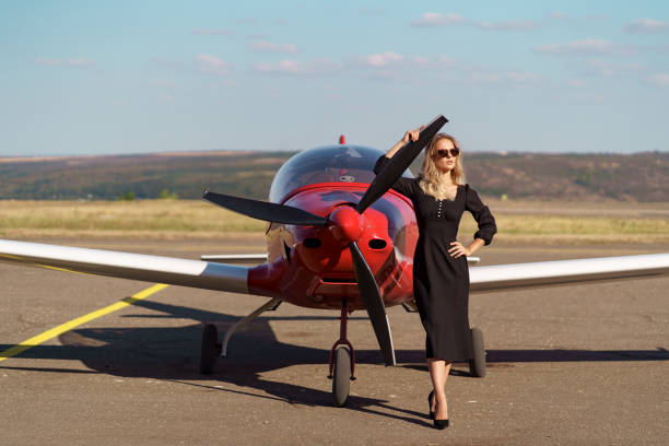 istock Glamorous woman posing on plane background 1286912336