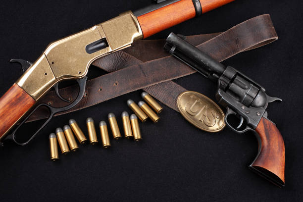 istock Old west rifle with revolver and ammunition 1286914377