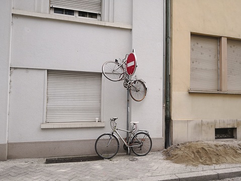 Bicycle fixed on the pillar. Urban joke or gag