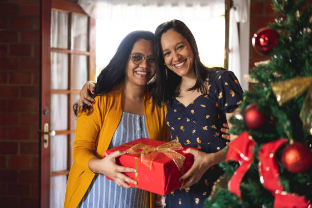 istock Women embraced holding christmas present 1286915576