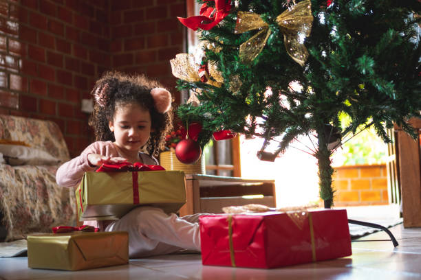istock Child unwrapping Christmas gift box 1286915918