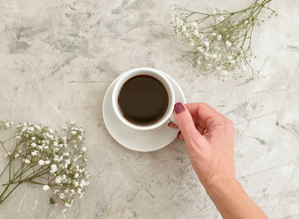 istock cup of coffee gypsophila flower on concrete background 1286922021