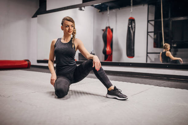 istock Fit woman kneeling in gym 1286922209
