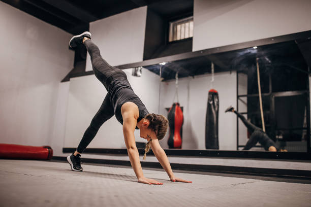 istock Fit woman doing warming up exercises in gym 1286922980