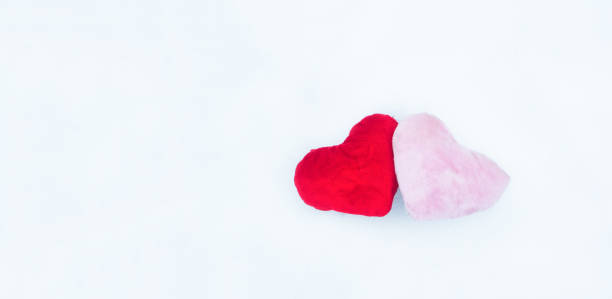 istock Pink and red heart on the snow. 1286926243