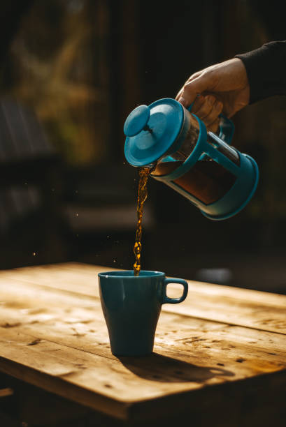 istock A turquoise cup is on the table, tea is poured into it. 1286929615