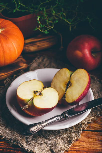 istock Two Halves of Red Apple on White Plate 1286931591