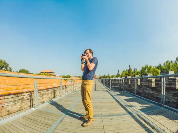 Photo of Enjoying vacation in China. Young man in Forbidden City. Travel to China concept. Visa free transit 72 hours, 144 hours in China