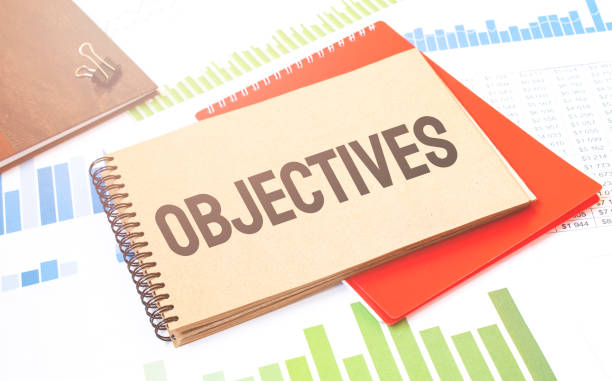 istock Word writing text OBJECTIVES on notepad. Business concept with red notepad and financial amounts. 1286933234