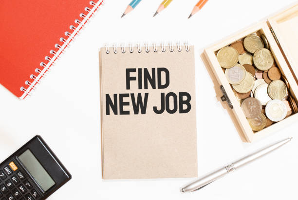 istock Calculator,red notepad, three colour pencils, silver pen and brown notebook with text FIND NEW JOB 1286933238