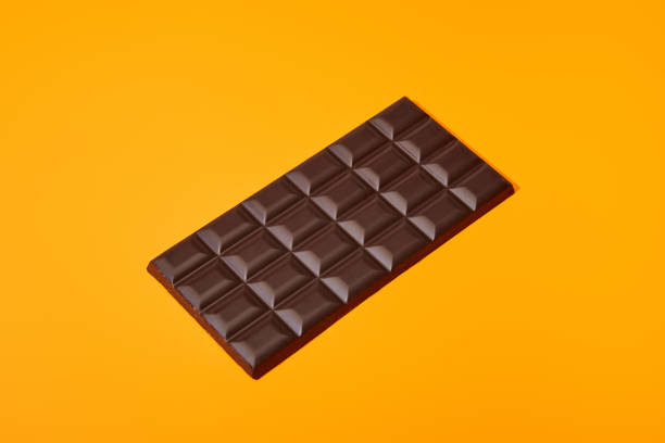 istock sweet dark chocolate bar on orange colorful background 1286938292
