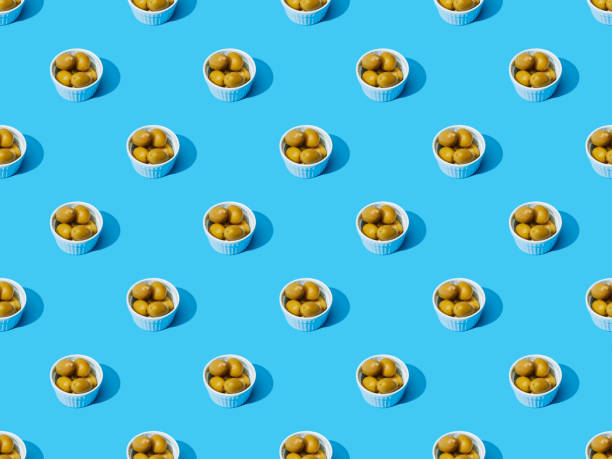 istock olives in bowls on blue colorful background, seamless pattern 1286938303