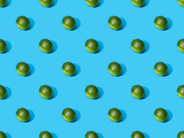 istock fresh whole limes on blue colorful background, seamless pattern 1286938319