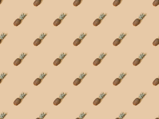 istock top view of whole ripe pineapples on beige background, seamless pattern 1286938328