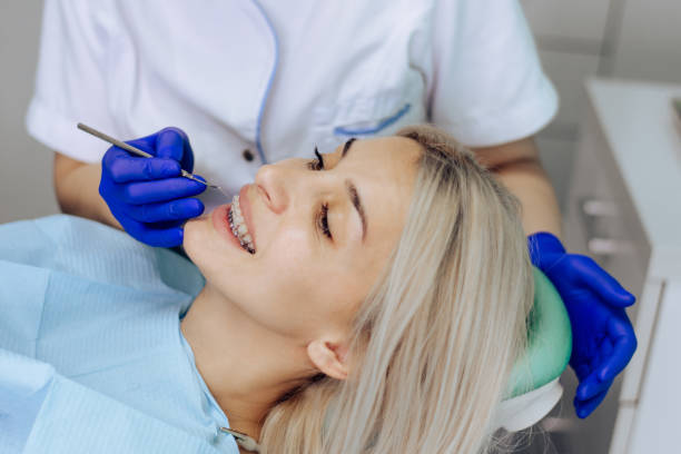 istock Young woman is having her teeth cleaned by a dentist 1286940636