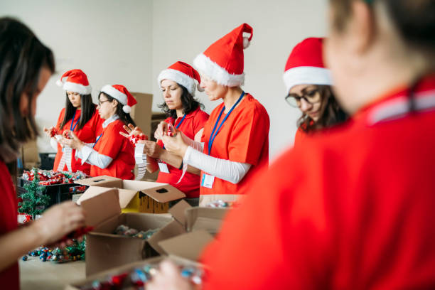 istock Female charity team during their work by making presents 1286940926