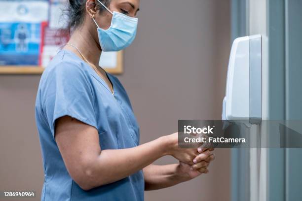 Nurse Sanitizes Hands Stock Photo - Download Image Now - Hand Sanitizer, Nurse, Hospital