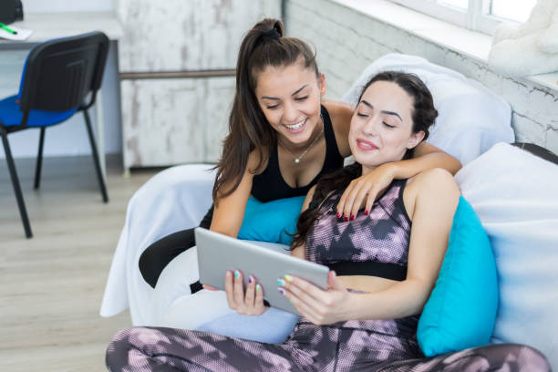 istock Two female students in isolation chat with friends on the net 1286941333