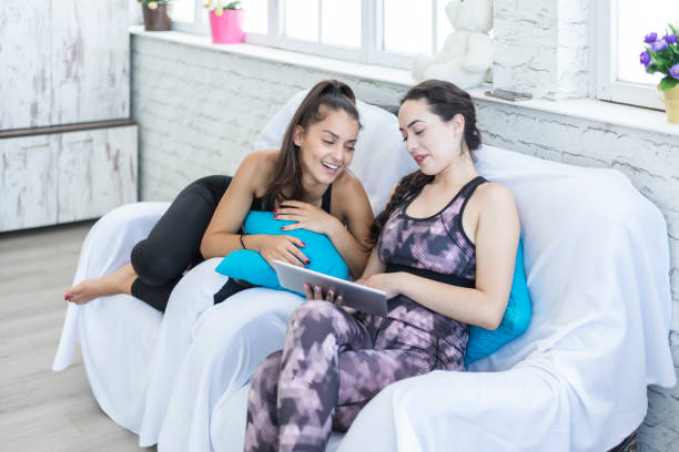 istock Two female students in isolation chat with friends on the net 1286941334