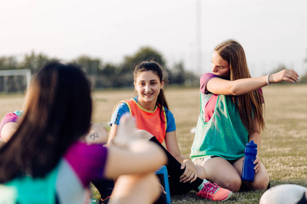 istock Girls from a rugby team resting and having fun after training 1286942448