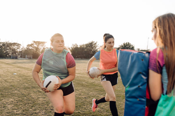 istock Female rugby players practicing attack on the training 1286942515