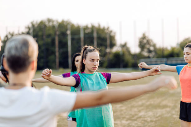 istock Female rugby team warming up for training 1286942546