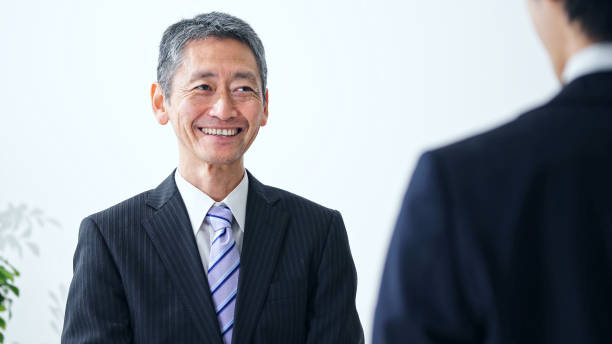 Smiling middle aged asian businessman. Interview concept. Smiling middle aged asian businessman. Interview concept. politician photos stock pictures, royalty-free photos & images