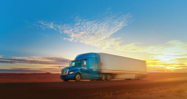 Blue and white semi-truck speeding on a single lane road USA Blue and white semi-truck speeding on a single lane road USA semi truck stock pictures, royalty-free photos & images
