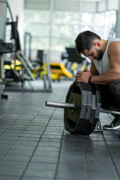 istock Athlete rests kneeling after finishing his training 1286948336