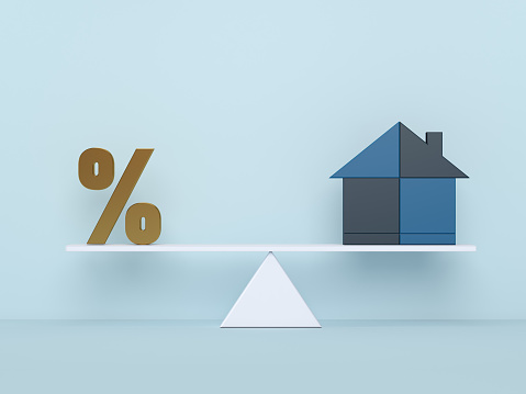 Percentage symbol icon and house balance on the scales