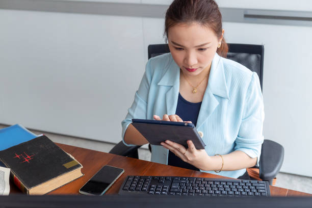 istock High angle view of beautiful entrepreneur using digital tablet 1286961661