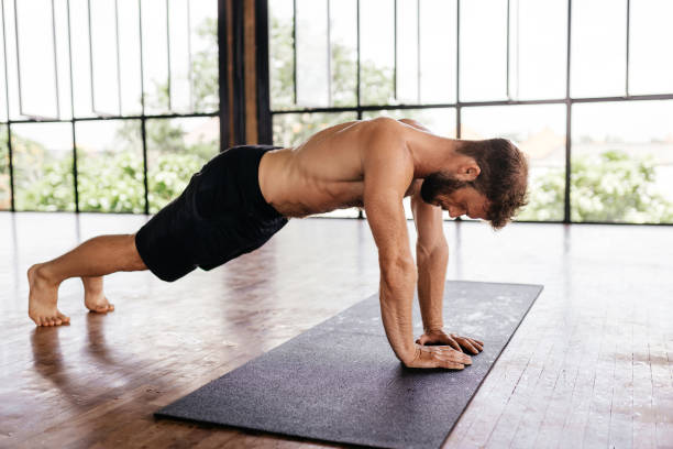 istock Yoga men workout in studio in front of a window 1286963071