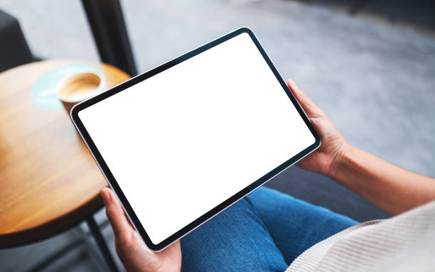 istock a woman holding digital tablet with blank white desktop screen 1286966918