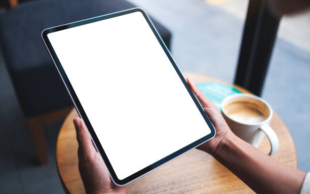 istock a woman holding digital tablet with blank white desktop screen 1286966940