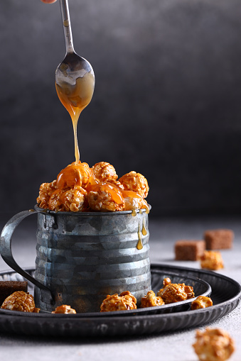 popcorn with caramel in a mug on the table