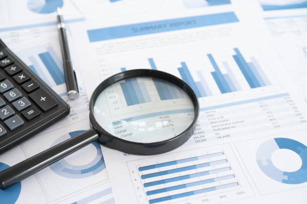 investment business report - tax financial figures analyzing banking document imagens e fotografias de stock