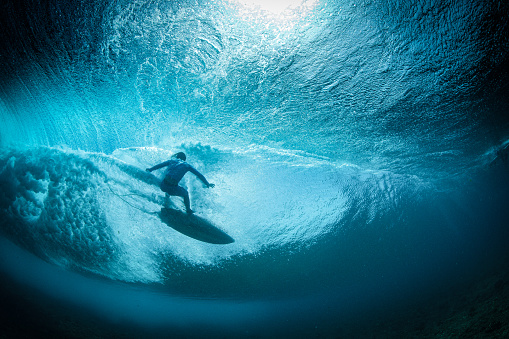 Surfer dropping in late under the lip Oahu