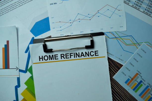 istock Home Refinance write on sticky notes with graphs and diagram isolated on office desk. 1286975251