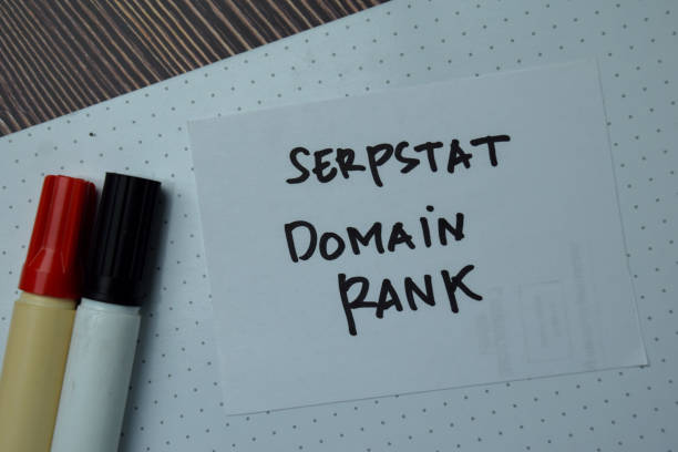 istock Serpstat Domain Rank write on a paperwork isolated on wooden table. 1286975274